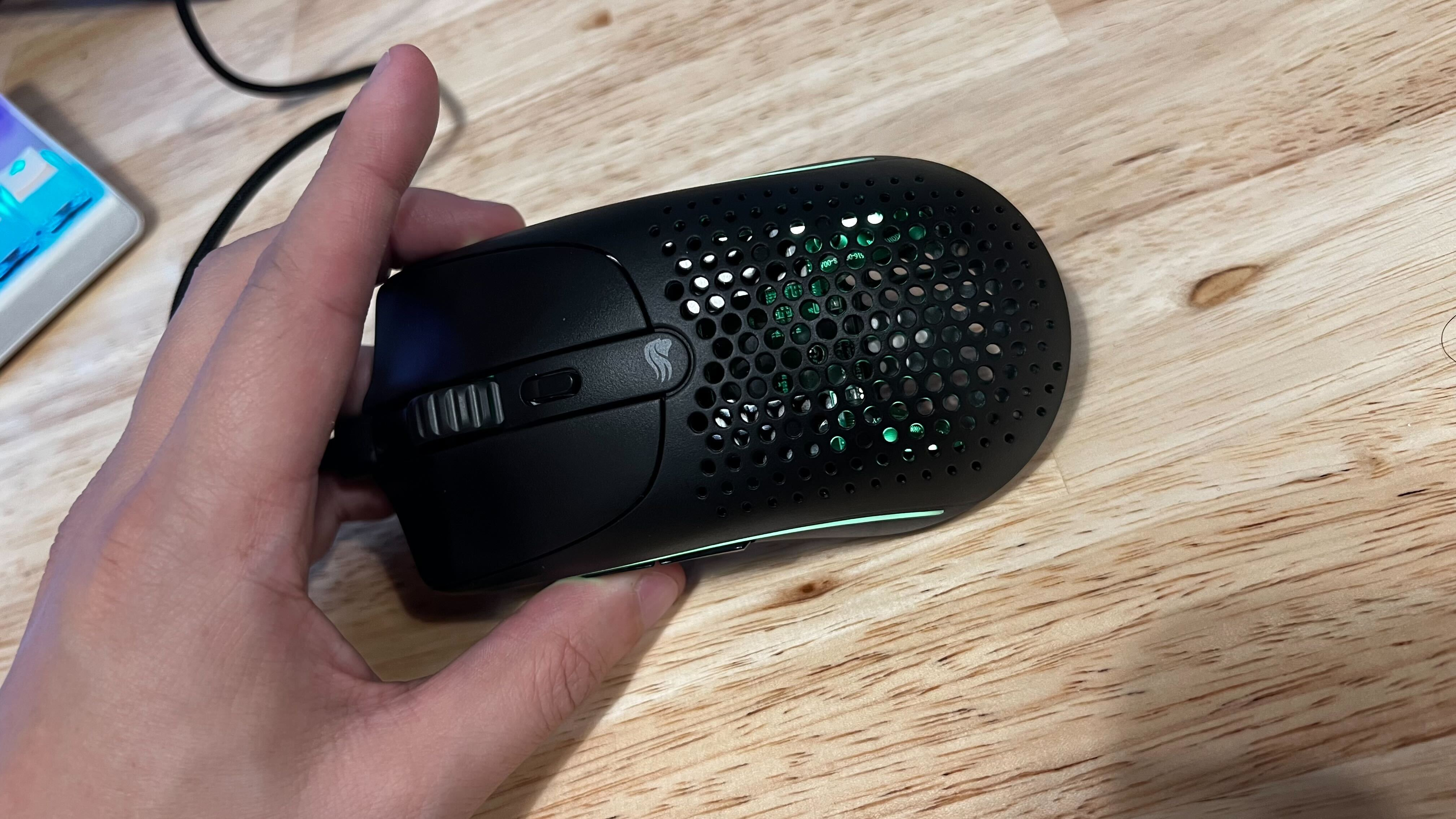 Glorious Model O2 wireless mouse in my hand.