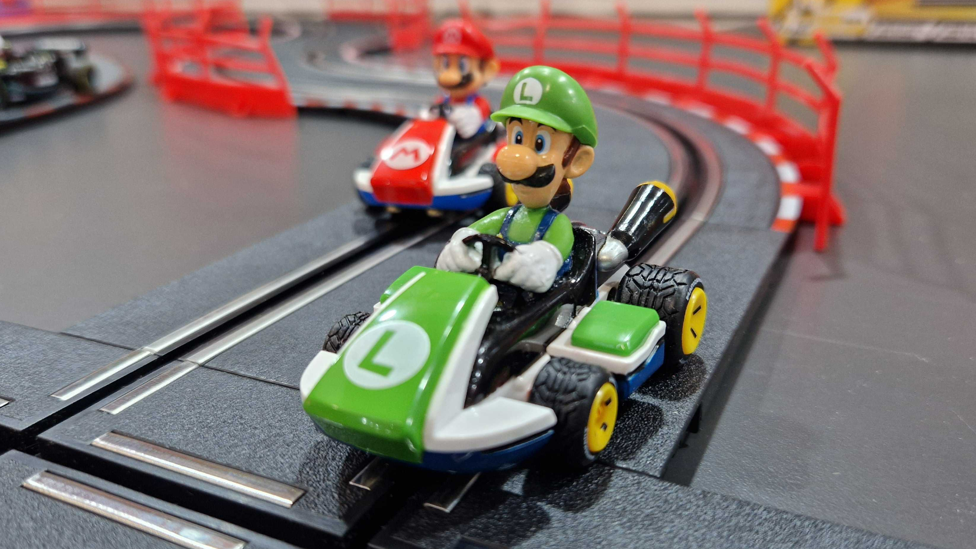 Luigi and Mario slot cars on a racetrack