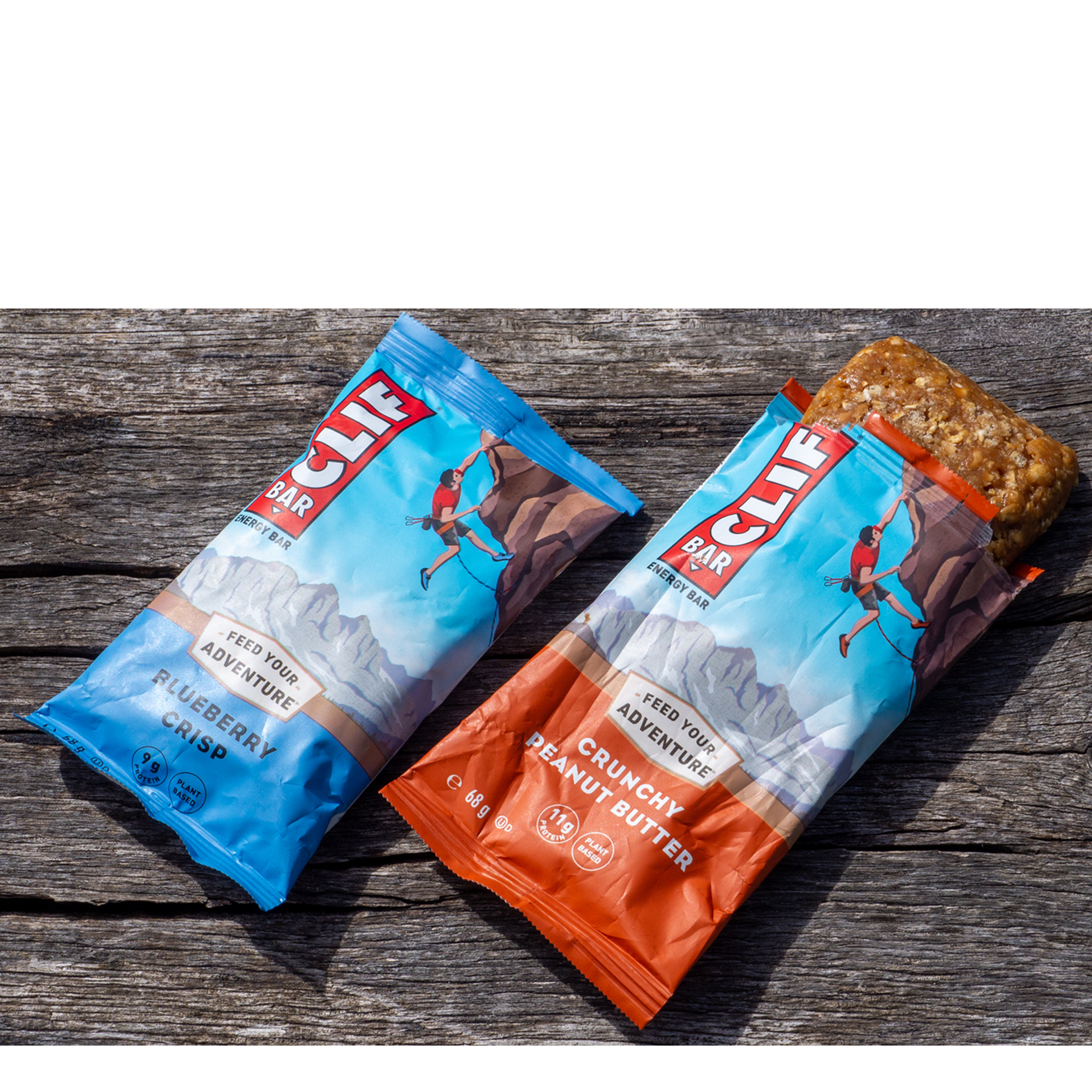 A pair of clif energy bars on a wooden bench