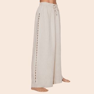 Flat lay cropped image of woman wearing white linen trousers