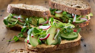 hummus sandwich with avocado and cucumber on rye bread