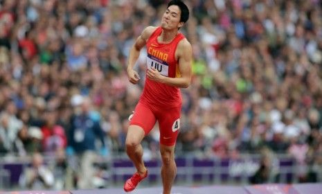 China&amp;#039;s Xiang Liu limps down the track to the finish line after crashing into his first obstacle and losing his chance at the gold.