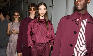Models wear burgundy jacket, trench coat and nylon blouse and shirt