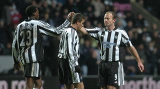 NEWCASTLE, UNITED KINGDOM: Newcastle's Alan Shearer (R) celebrates with Shola Ameobi (L) and Laurent Robert (C) after scoring against SC Heerenveen to make it 2-0 during their UEFA Cup football match at St James' Park in Newcastle, 24 February 2005. AFP PHOTO Paul Barker (Photo credit should read PAUL BARKER/AFP via Getty Images)