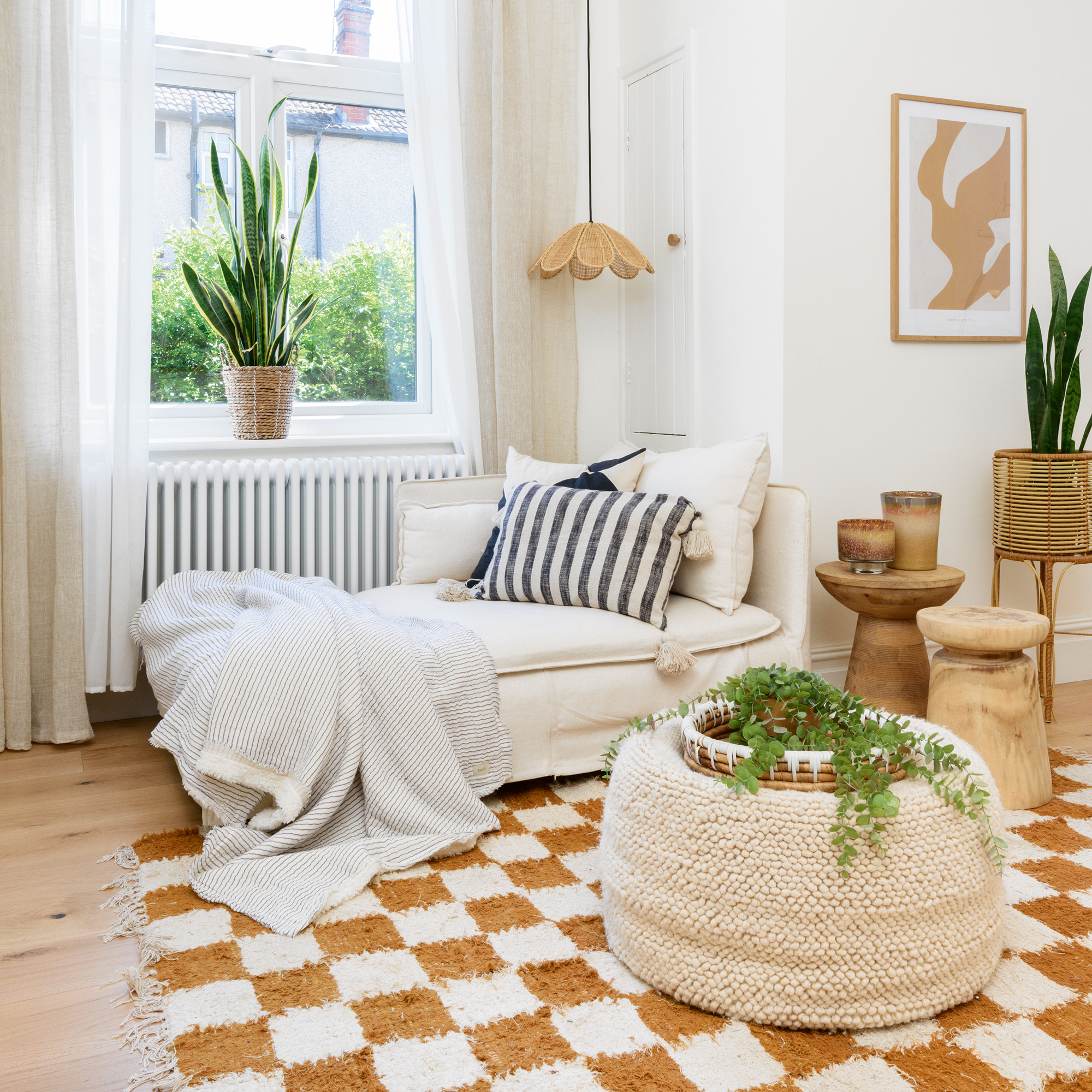 a cosy snug area with chaise longue sofa and checkered thick pile rug