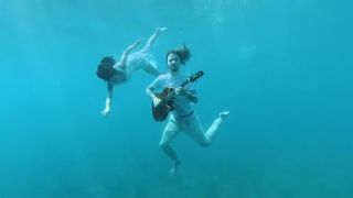Bernth playing guitar underwater