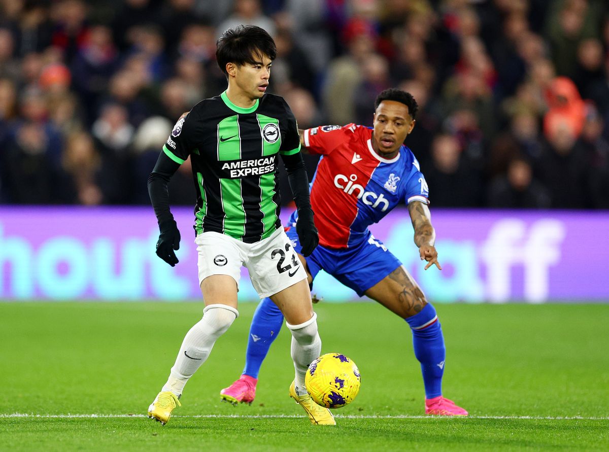 Kaoru Mitoma of Brighton carries the ball while under pressure from Nathaniel Clyne of Newcastle during a 2023 Premier League match