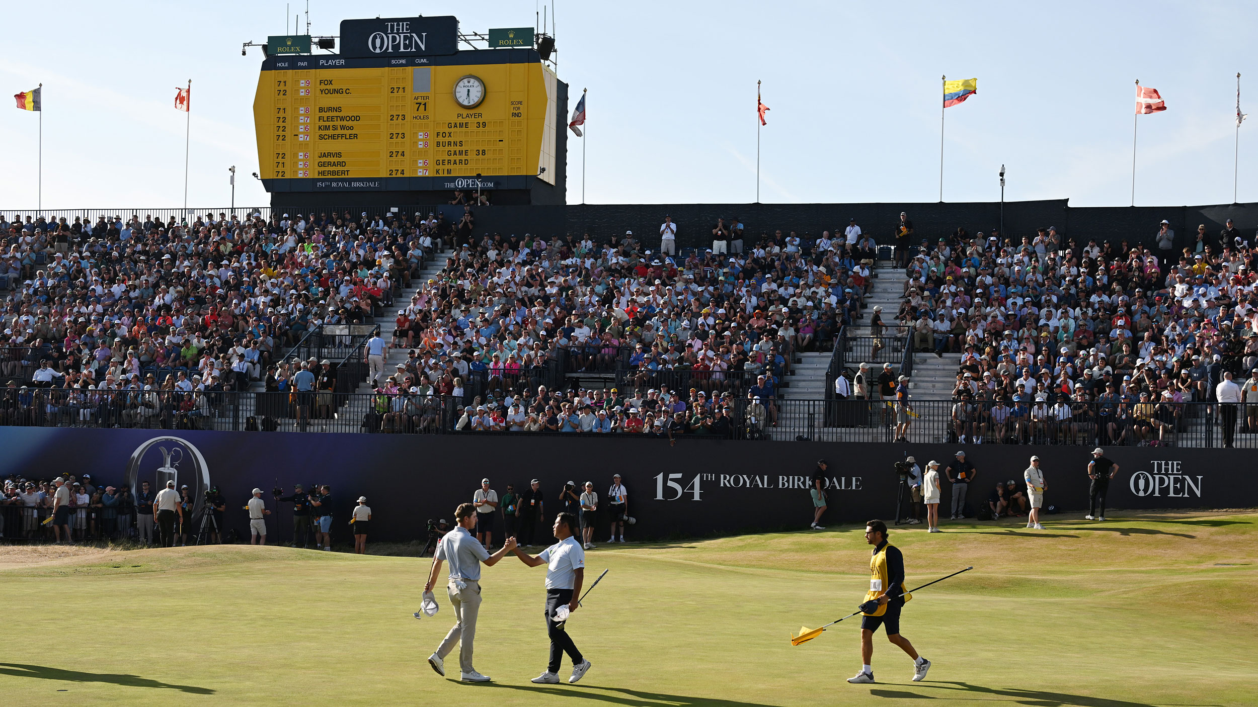 Si Woo Kim and Ryan Gerard shake hands on the final green at The Open in 2026
