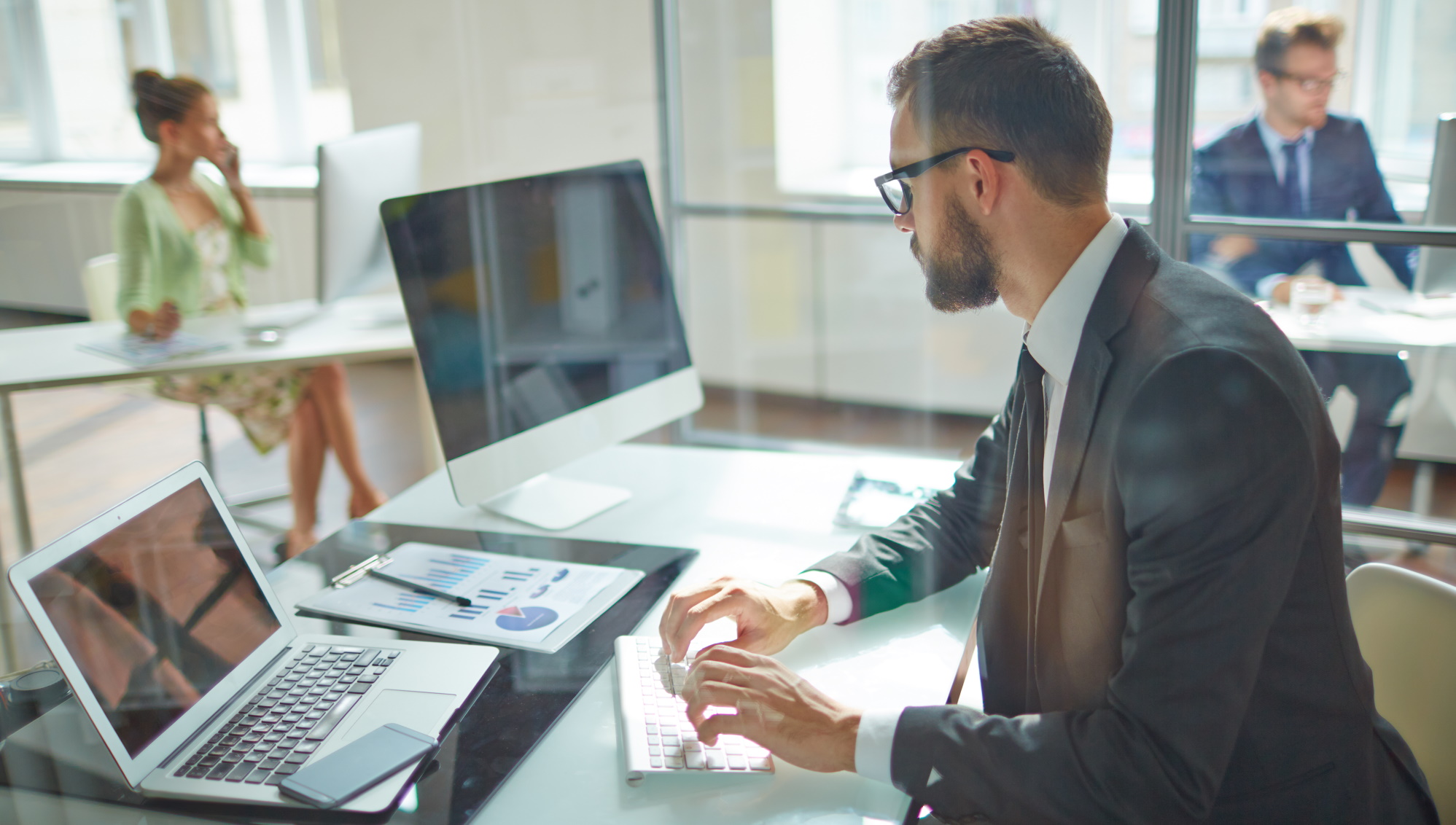 A man was sitting at a table and working at a computer