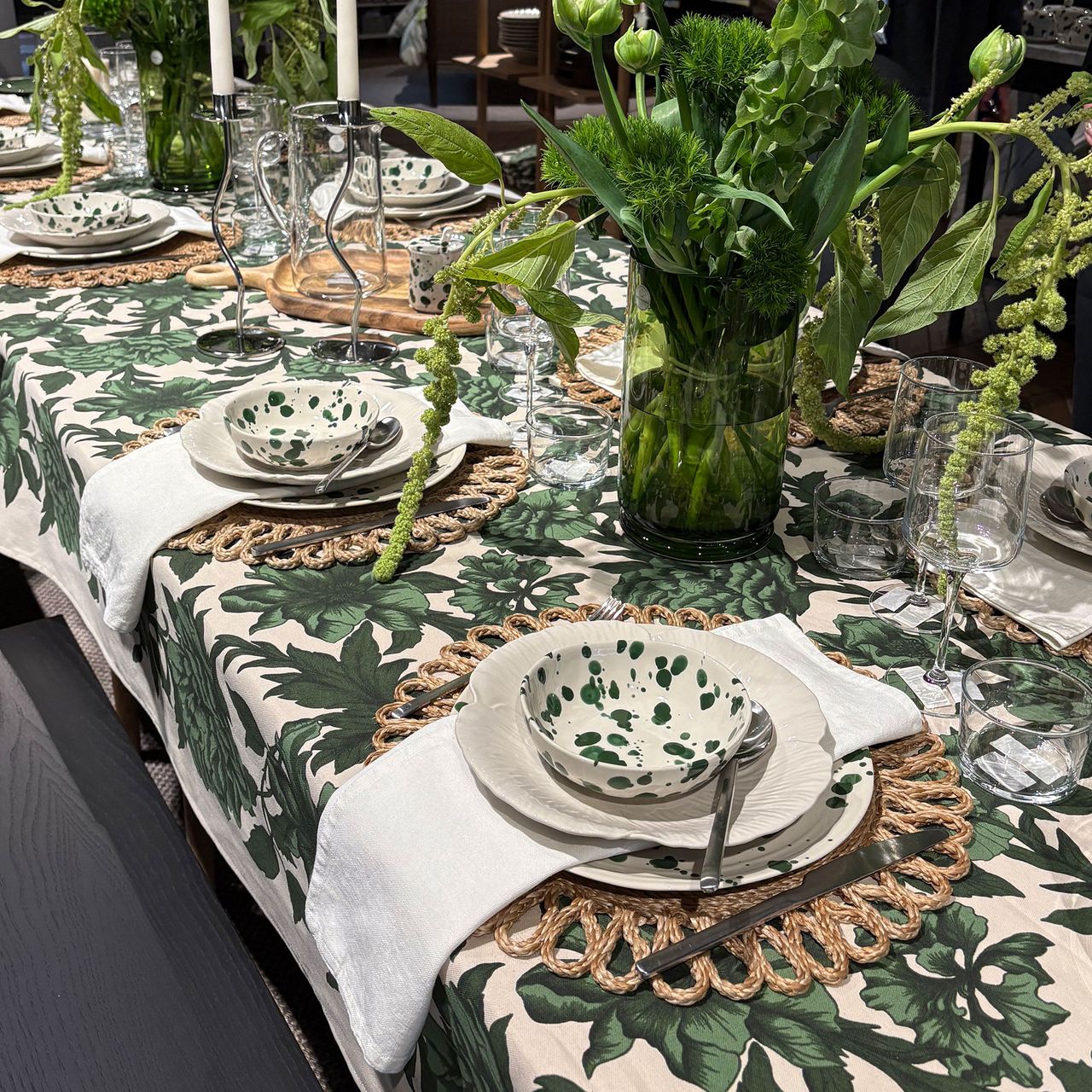 Green table cloth with rattan place mat and splatter bowl