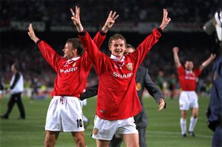 Ole Gunnar Solskjaer and Teddy Sheringham celebrate with a treble salute after Manchester United's Champions League final win over Bayern Munich in May 1999.