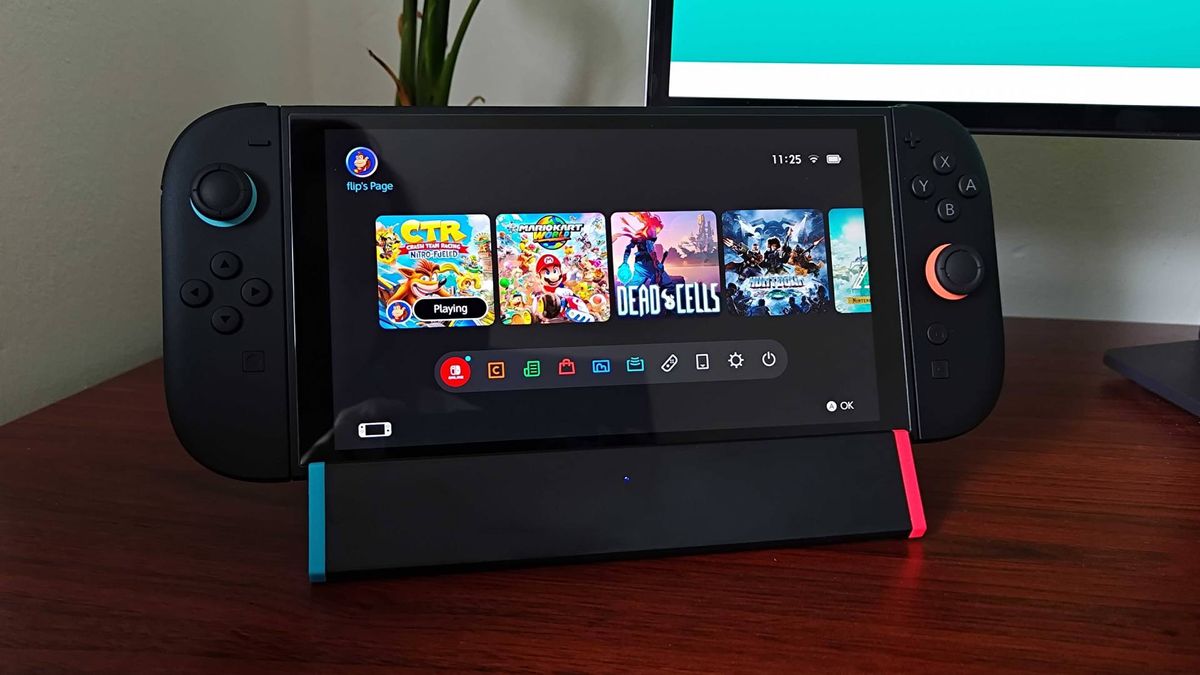 SIWIQU Switch 2 dock with handheld on top sitting on woodgrain desk.
