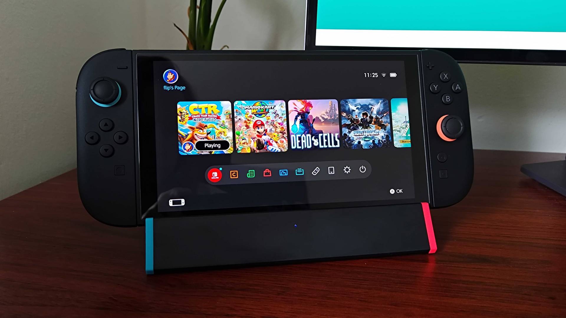 SIWIQU Switch 2 dock with handheld on top sitting on woodgrain desk.