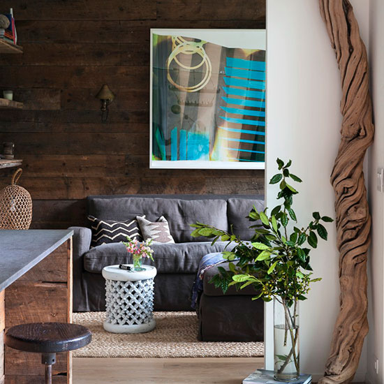media room with linen sofa and driftwood accessories and stool