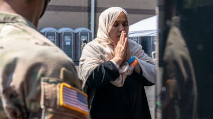 An Afghan refugee boards a bus in Chantilly, Virginia, in 2021.