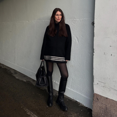 Annabel wearing a mini dress with knee-high boots