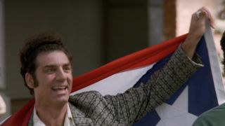 Kramer holding the Puerto Rican flag on Seinfeld