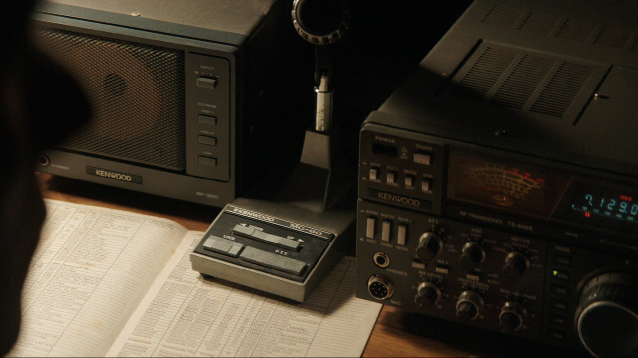 A screenshot of radio equipment on a table in Pluribus episode 4