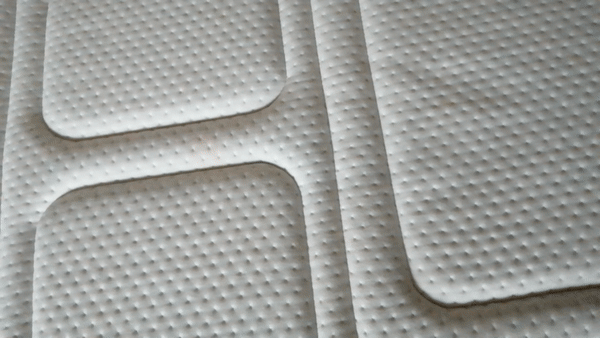 Hand pressing on surface of Otty Pure mattress