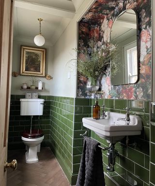 Green bathroom with floral wallpaper and fresh grass bouquet by Hannah Young