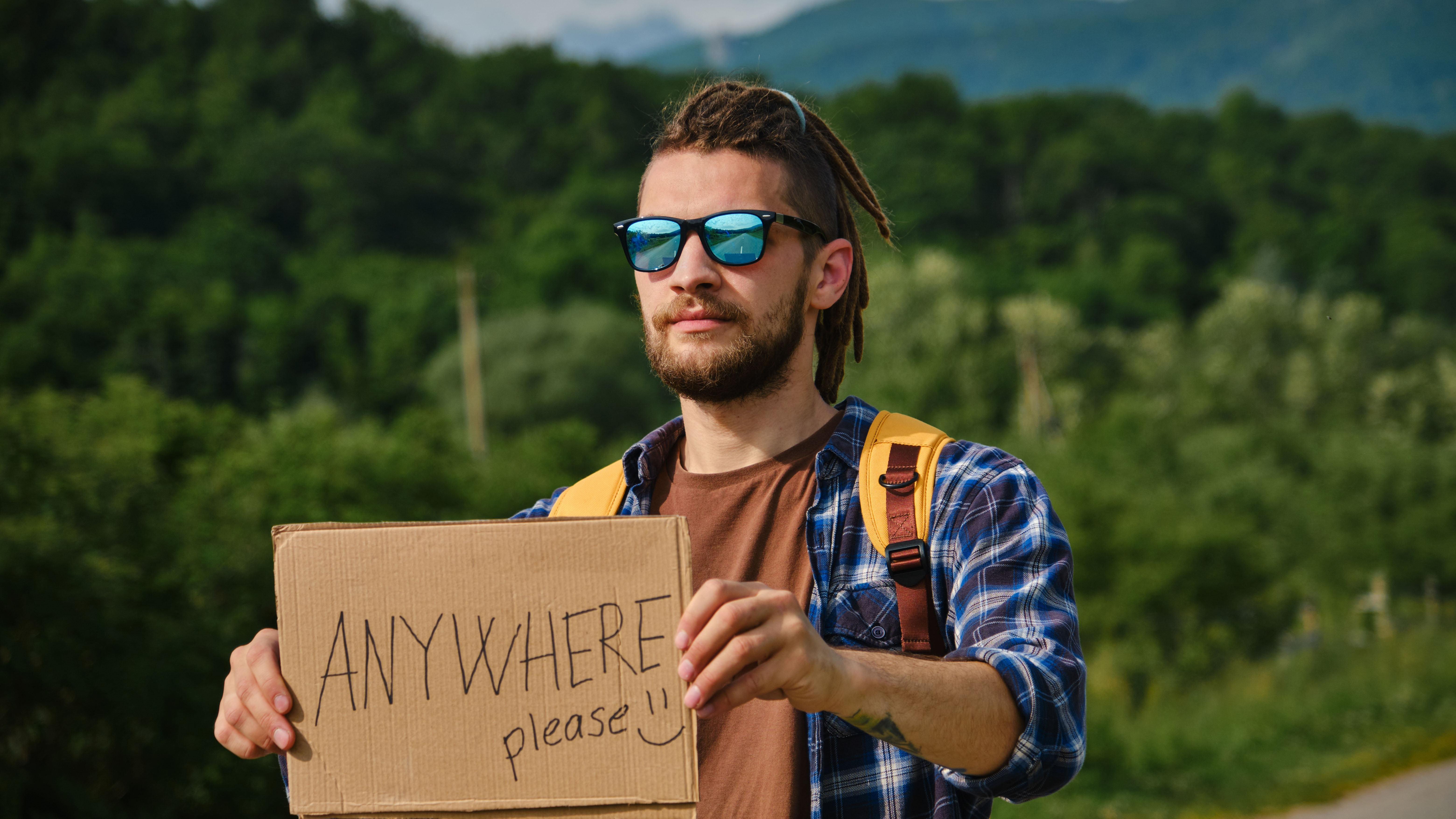 Hitchhiker with sign.