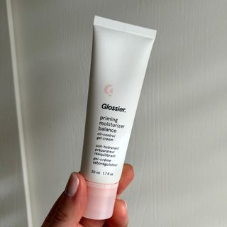 Laura holding Glossier Priming Moisturiser Balance - best moisturisers for oily skin