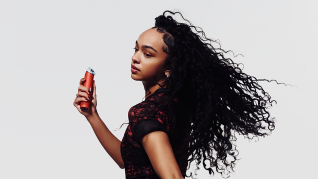 Woman holding red Dyson HushJet Mini Cool Fan