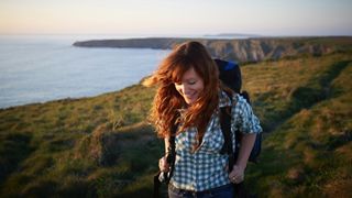 woman smiling and hiking