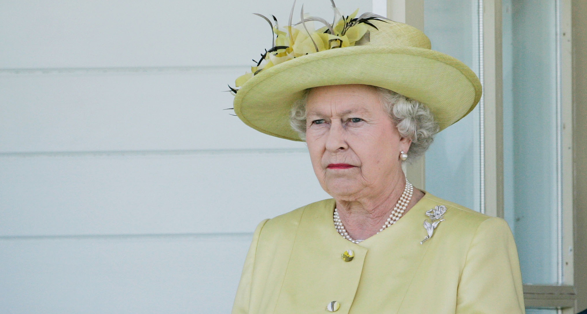 Queen Elizabeth wearing a green hat and coat