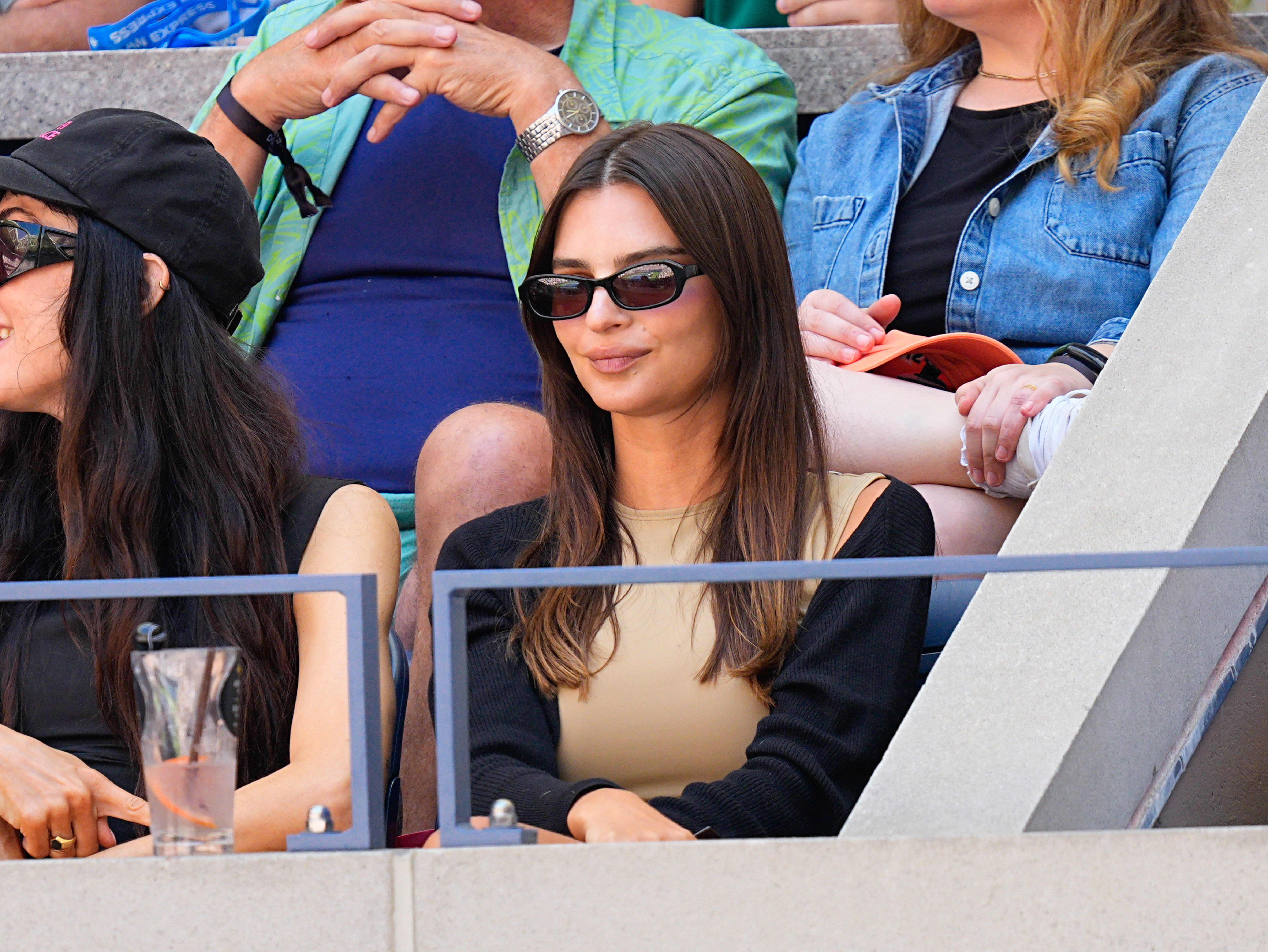 Emily Ratajkowski wearing dark sunglasses with brown hair
