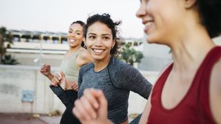 Three women running outdoors