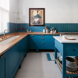 kitchen with dark blue cabinetry and blue and white tide-lines