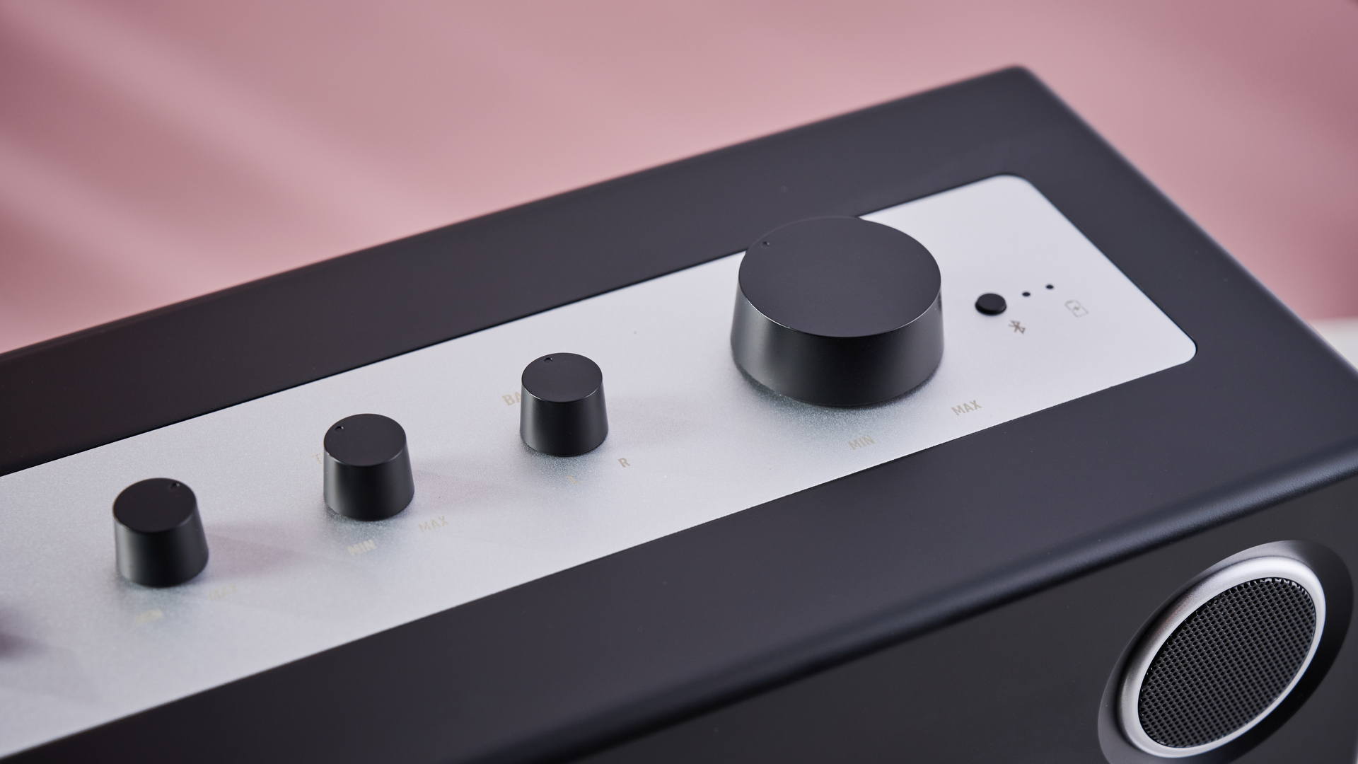 A closeup of the switches on top of the We Are Rewind GB-001, showing the Bass Level knob, Treble Level knob, Balance knob, Volume knob and Bluetooth button.