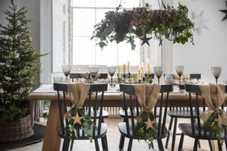 Christmas dining area with foliage, hessian decorations and a tree