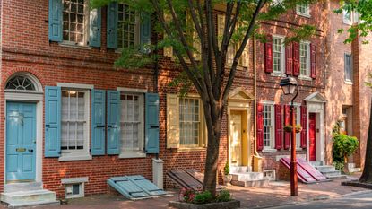 red brick row houses with colorful doors and shutters