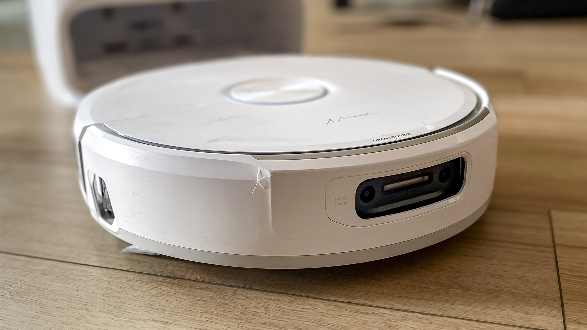 Narwal Freo 20 robot vacuum on a kitchen floor