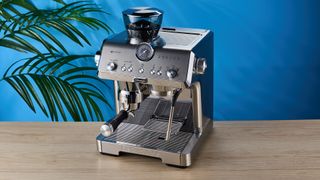 De'Longhi La Specialista Opera is a stainless steel manual espresso machine with smart tamping, a group handle, steam wand, and grinder