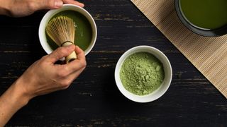 A layout of matcha tea powder with whisk