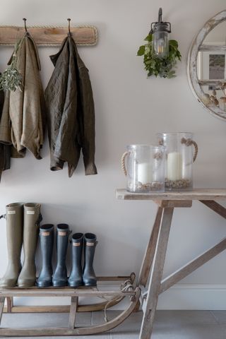 coastal cottage hallway with sleigh as boot stand