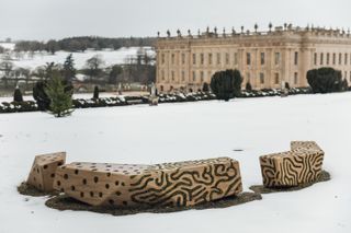 Exterior of Chatsworth house in the snow with Joris Laarman benches