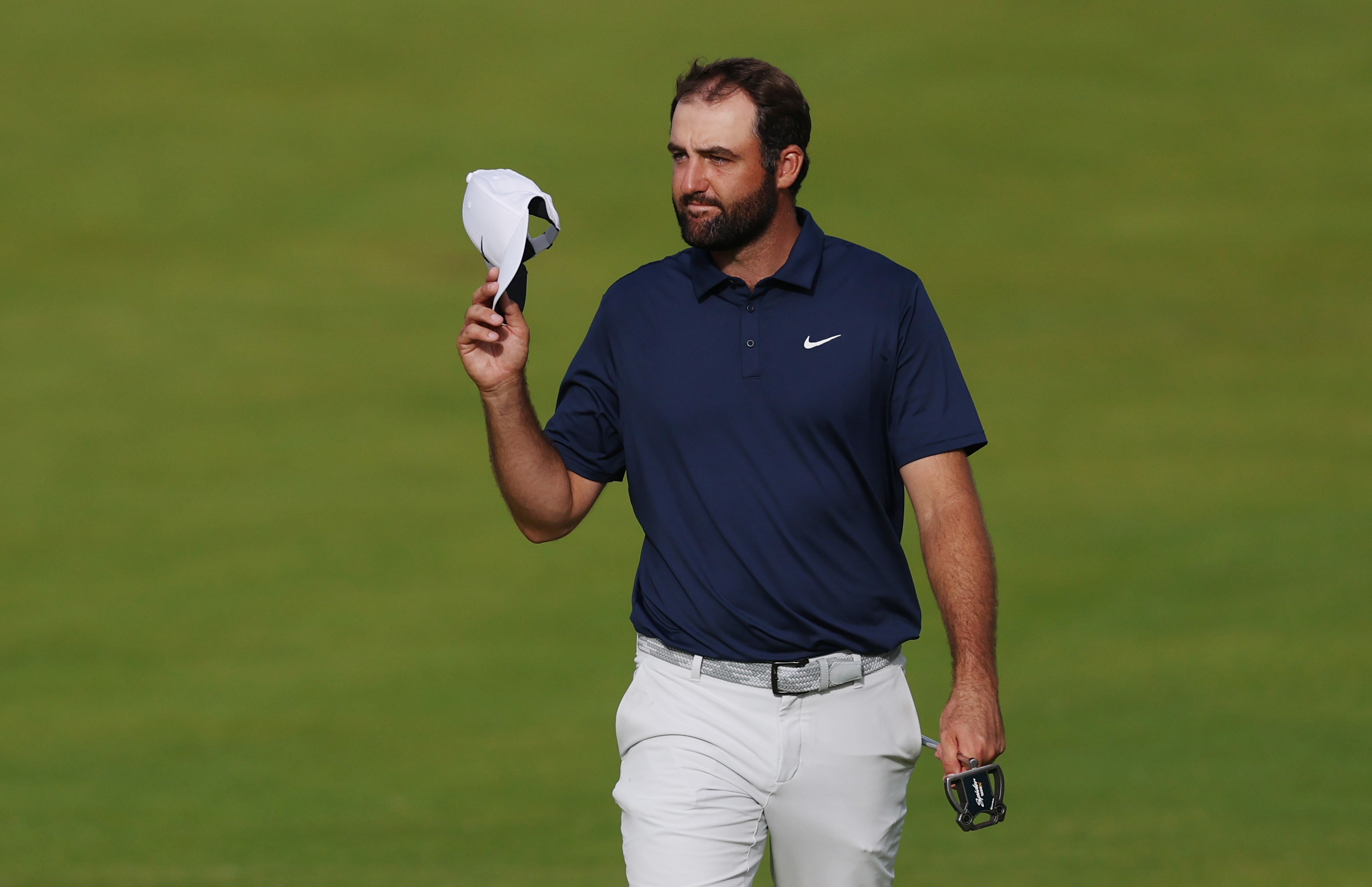 Scottie Scheffler tips his cap to the spectators at the 2025 Open