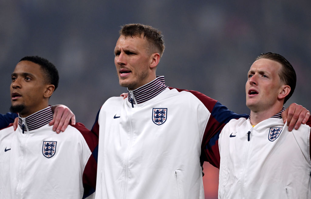 Dan Burn of England sings the national anthem with teammates Ezri Konsa and Jordan Pickford prior to the FIFA World Cup 2026 European Qualifier between England and Albania at Wembley Stadium on March 21, 2025 in London, England