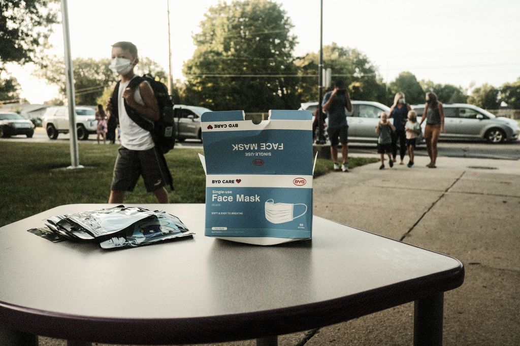 Box of face masks outside school.