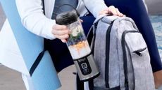 A Ninja Blast Blender being placed into a backpack