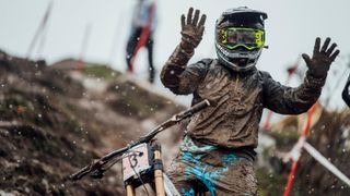 A mud-covered Marine Cabirou poses for the camera at UCI DH World Championships in Leogang, Austria on October 11, 2020