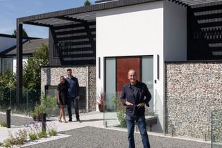 Kevin McCloud stands outside the new build home