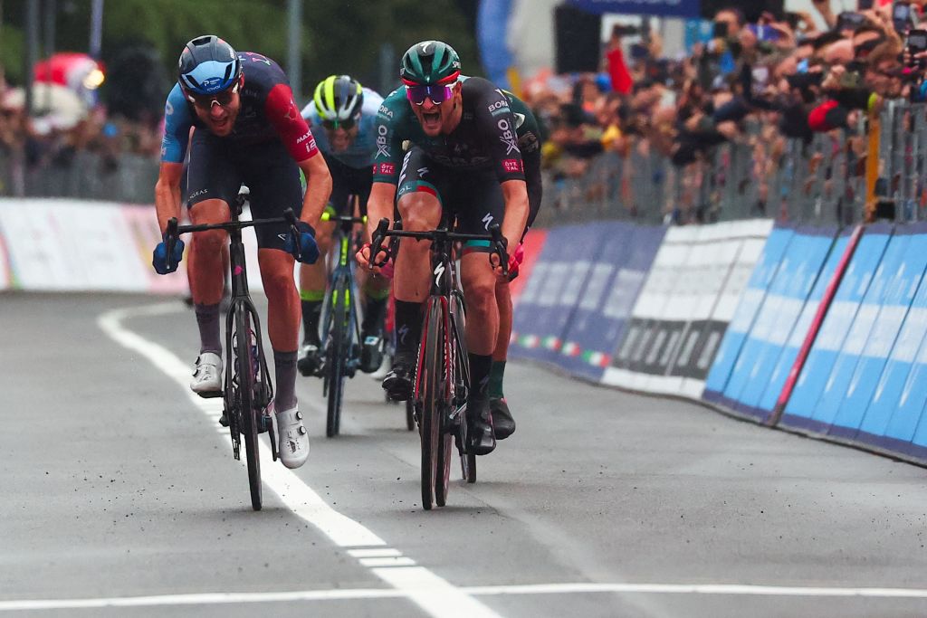 BORA hansgrohes German rider Nico Denz C sprints in the last meters to win ahead of Israel Premier Techs Canadian rider Derek Gee L the fourteenth stage of the Giro dItalia 2023 cycling race 193 km between Sierre and Cassano Magnago on May 20 2023 Photo by Luca Bettini AFP Photo by LUCA BETTINIAFP via Getty Images