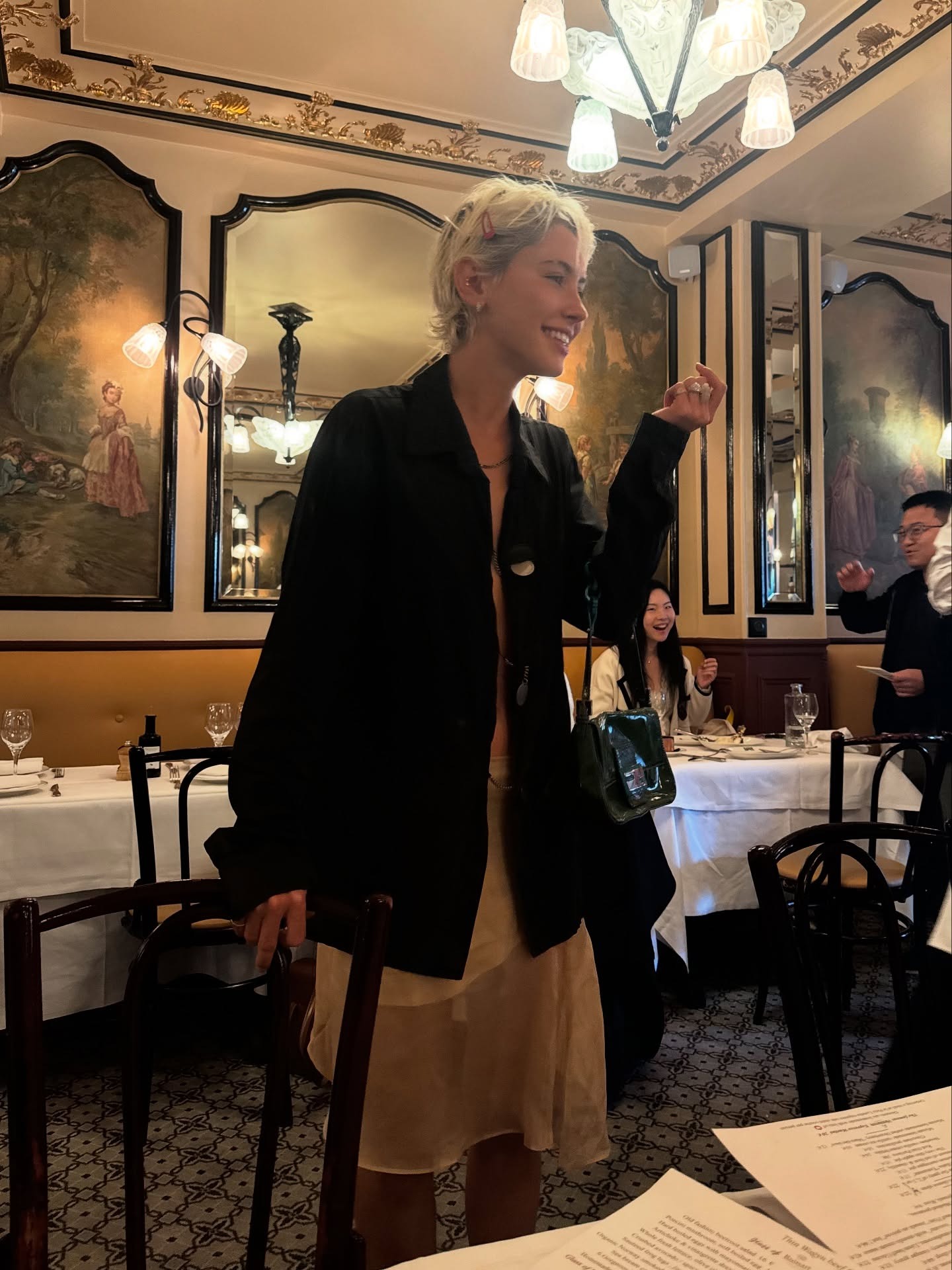 Fashion person Iris Law wears a knee length skirt trend. She wears a sheer skirt.