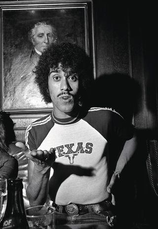 Phil Lynott backstage wearing a t-shirt that reads 'Texas'