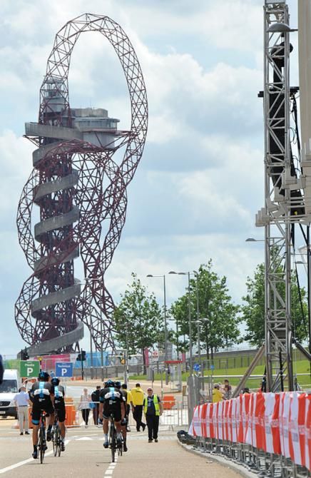 Team Sky Procycling rides away from the starting podium in the Olympic park.